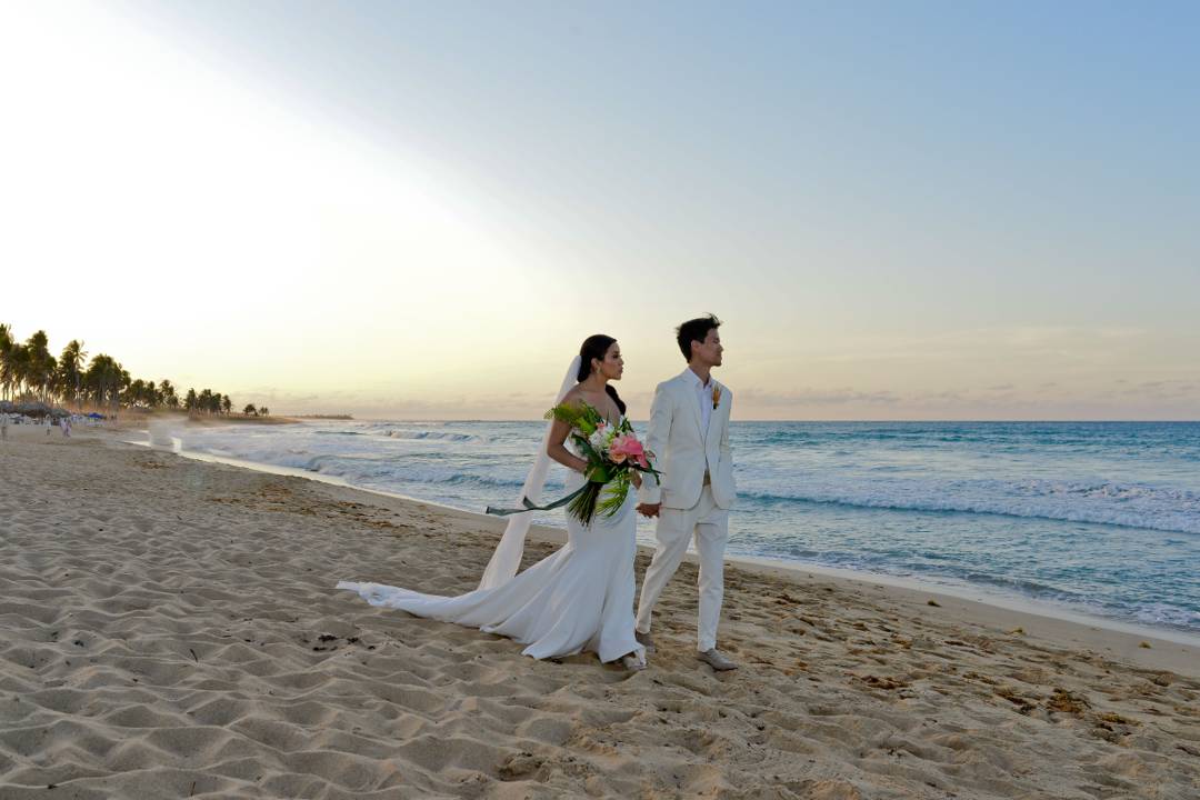 Couple beneath a floral ceremony gazebo