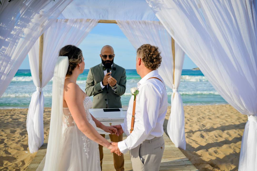 Couple beneath a floral ceremony gazebo
